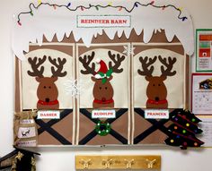 a bulletin board decorated with reindeer heads and christmas lights on it's sides, hanging from the wall