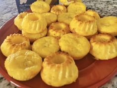 there are many small pastries on the plate next to a box of cookies and a bag of milk