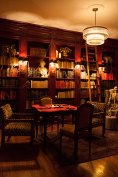 a living room filled with lots of books and furniture