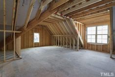 an attic with wooden framing and exposed walls