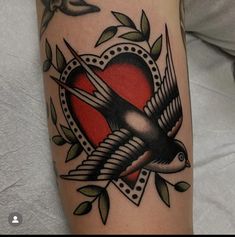 a tattoo with a bird and heart on it