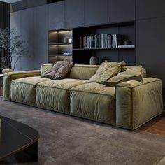 a living room filled with lots of furniture and a book shelf on top of a wall