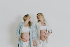 two pregnant women standing next to each other