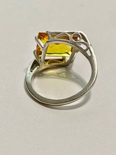 This Vintage 10k White Gold Yellow Sapphire Ring is magnificent! The ring showcases a Emerald set in a four prong setting The Sapphire stone has beautiful color. The stone measures approximately 10mm x 12mm = 6.84 carats The setting is beautiful with a unique style The ring is marked U - 10k Weight- 3.61g Size-7 Vintage Yellow Jewelry With Center Stone, Elegant Yellow Sapphire Round Cut Jewelry, Luxury Yellow Sapphire Round Cut Jewelry, Luxury Yellow Sapphire Round Jewelry, Round Yellow Sapphire Gemstone Jewelry, Sapphire Ring Vintage, Yellow Sapphire Ring, Vintage Sapphire Ring, Emerald Set