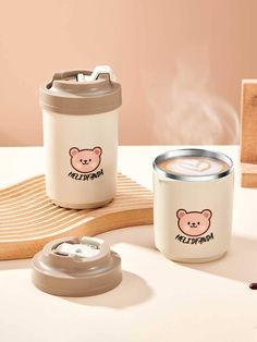 two coffee mugs sitting next to each other on a table