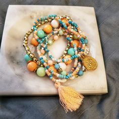 Stretchy Bead Charm Tassle Boho Chic Bracelet Beaded Bracelet With A Charm And Tassle. Peach, Blue, And Gold Colored. Boho, Hippie, Trendy. Charm Bracelet Bead Bracelet. Bohemian Stretch Bracelet With Faceted Beads, Bohemian Stretch Bracelet With Faceted Beads For Beach, Bohemian Stretch Bracelet With Round Beads For Beach, Bohemian Beach Stretch Bracelet With Faceted Beads, Bohemian Stretch Bracelet For Vacation, Bohemian Bracelets With Faceted Beads For Beach, 8mm Beaded Bracelets For Beach, Bohemian Faceted Beads Bracelets For Beach, Large Cuff Bracelet