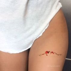 a woman's thigh with flowers on it