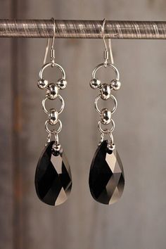 "Stainless steel dangle earrings with jet black, Austrian crystal by Swarovski. Sturdy for everyday wear, but elegant as they shine and swing with every movement. Approximately 2\" long and .5\" inches wide." Modern Crystal Dangle Earrings For Evening, Elegant Gunmetal Stainless Steel Jewelry, Elegant Gunmetal Jewelry In Stainless Steel, Elegant Stainless Steel Jewelry In Gunmetal, Modern Black Sterling Silver Earrings, Sterling Silver Dangle Crystal Earrings For Evening, Elegant Hypoallergenic Metal Crystal Earrings, Nickel-free Black Dangle Jewelry, Black Nickel-free Dangle Jewelry