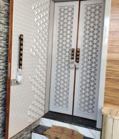 the inside of a bathroom with an open door and tiled walls, along with black and white tiles on the floor