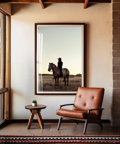 a man riding on the back of a horse next to a brown chair and table