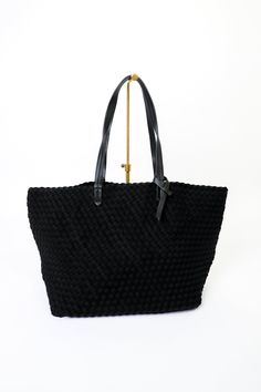 Lydia Woven Neoprene Tote Color: Black Bag Size: 13” H x 21.5” W x 9” D Interior Lining with Pockets Vegan Leather Handles Woven Neoprene Poly, Lining Poly Interior slip pockets Zipper pocket Ahdorned Modern Black Woven Bucket Bag, Luxury Black Woven Bag, Black Intrecciato Weave Top Handle Bucket Bag, Black Woven Leather Shopping Bag, Eco-friendly Black Bucket Bag With Braided Handles, Neoprene Tote, Black Bag, Leather Handles, Leather Handle