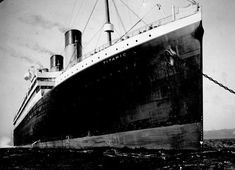 an old photo of a large ship in the water with chains on it's side