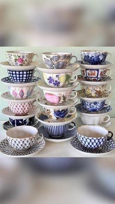 there are many cups and saucers stacked on top of each other