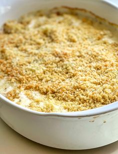 a casserole dish with crumbs in it sitting on a table top