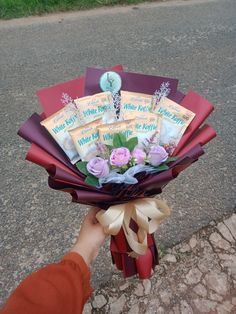 a person holding a bouquet of flowers on the street