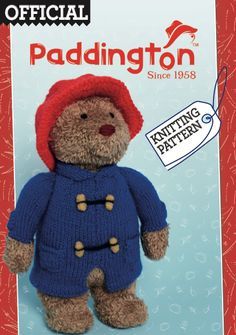 a brown teddy bear wearing a blue jacket and red hat on top of a card