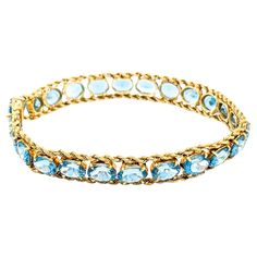 Sparkling Blue Topaz & 14K Gold Chain Bracelet Immerse yourself in the vibrant elegance of this stunning bracelet, crafted in the warm glow of 14kt yellow gold. Adorned with twenty-four captivating oval-cut blue topaz stones, each measuring 5 x 7mm, this piece is a symphony of color and light. Measuring 7 inches in length, it perfectly encircles the wrist with a weight of 14.78g, offering both comfort and undeniable style. This bracelet is not just an accessory but a treasure, adding a splash of serene blue to your collection. 00098045 A video on this item is available upon request. New arrivals everyday! Follow our store to see more. Blue Topaz Stone, Gold Bracelet Chain, Chain Bracelet, Blue Topaz, Gold Chains, Topaz, Jewelry Bracelets, Sparkle, Yellow Gold