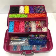 a pink plastic case filled with lots of different types of bracelets and other items