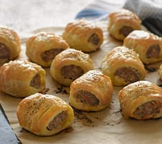 some sausage rolls are on a piece of parchment paper