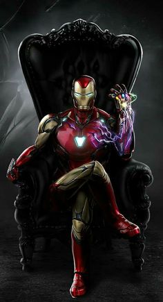 iron man sitting in a chair with his hands on the arm and glowing light up