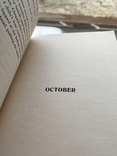 an open book with the word october printed on it