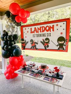 an outdoor birthday party with balloons, cake and dessert table set up for the event