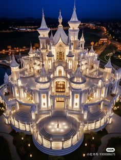 an aerial view of a castle lit up at night