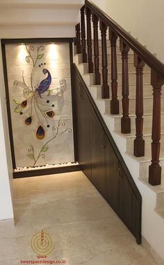 the stairs are decorated with peacocks and flowers on glass panels, along with marble flooring