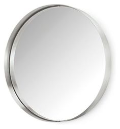 a round mirror hanging on the wall above it's head, with a metal frame