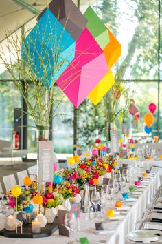 the tables are set with colorful decorations and place settings for guests to sit down at