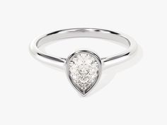 a white gold ring with a pear shaped diamond