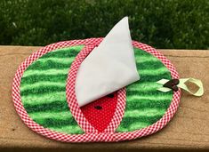 a red and white plate topped with a piece of cake on top of a wooden table