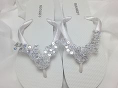 This beautiful white flip flops is wrapped with white ribbon, and adorned with silver bridal lace with silver sequins. Ribbon color is white if you are needing other colors of ribbon or decoration please contact me and will be happy to accommodate you!  Available in silver and white. Other colors available please see last picture. All flip flops are handmade to order and the production time is 5-7 business days and then please allow additional time for shipping.   Amazing for beach, weddings, fl Bridal Flip Flops, Silver Flip Flops, Beach Wedding Sandals, Wedding Flip Flops, Flip Flops Beach, Sandals Wedding, White Flip Flops, Bridal Sandals, Silver Lace