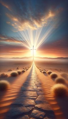 an image of a cross in the middle of a desert with sun rays coming through it