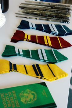 a table topped with lots of different colored ties