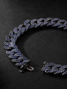 A statement take on the classic chain bracelet, SHAY's design is encrusted throughout with brilliant blue sapphires all over. It's cast from blackened gold for extra edge and secures with a smooth clasp. Maintain the shine by cleaning gently in warm, soapy water and finish with a gem cloth. Luxury Sapphire Bracelet, Luxury Sapphire Jubilee Bracelet, Luxury Sapphire Bracelet Jewelry, Luxury Sapphire Cubic Zirconia Diamond Bracelet, Luxury Sapphire Bracelets With Diamond Accents, Luxury Sapphire Bracelet With Diamond Accents, Luxury Sapphire Diamond Bracelet With Accents, Luxury Blue Sapphire Bracelets, Luxury Sapphire Jewelry For Party