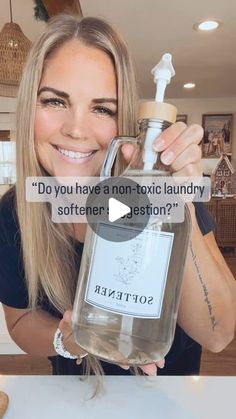 a woman holding up a bottle of alcohol with the caption do you have a non - tonic laundry softener? question