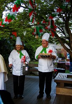 two chefs standing on a deck holding food