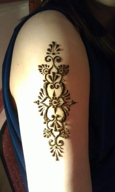 the back of a woman's arm with an intricate design on it