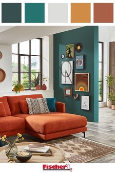 a living room with orange and teal colors on the walls, furniture and decor