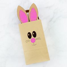 a brown paper bag with bunny ears on it sitting on top of a marble counter