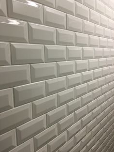 a bathroom with white tiles on the wall