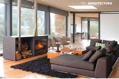 a living room filled with furniture and a fire place next to a large glass window