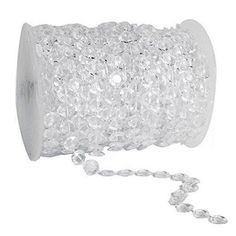 a spool of clear crystal beads on a white background with a chain attached to it