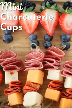 mini charcutette cups with cheese, ham and blueberries on them are ready to be eaten