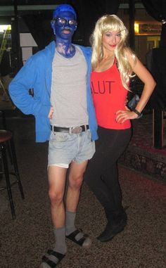 a man and woman in costume standing next to each other with blue paint on their faces