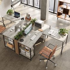 an overhead view of a desk with two computers on it and some plants growing out of the top