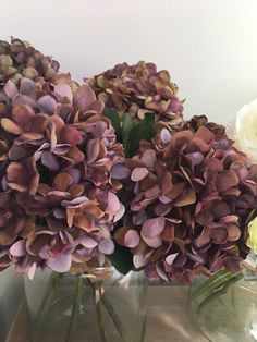 two vases filled with purple and white flowers