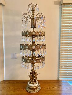 an ornate chandelier stands on a wooden table