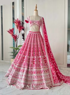 a pink and white lehenga is displayed on a mannequin in front of a